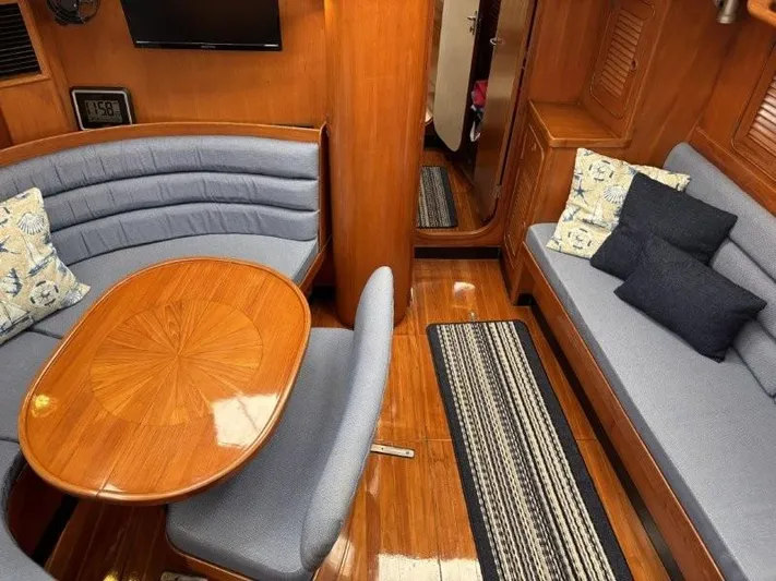 Seacape Yacht Photos Pics Luxurious interior of a 1996 Hylas 46 yacht with elegant wood finish and comfortable seating.