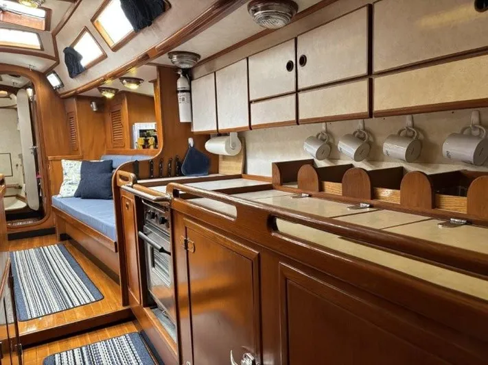 Seacape Yacht Photos Pics Interior of a 1996 Hylas 46 yacht with wooden cabinetry and cozy seating.