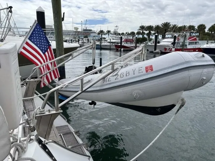 Seacape Yacht Photos Pics Sailboat docked with American flag and dinghy, Hylas 46, 1996 model.