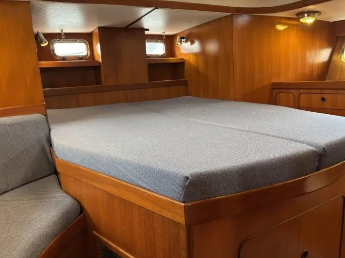 Seacape Yacht Photos Pics Interior cabin of a 1996 Hylas 46 yacht with wooden finish and comfortable bedding.