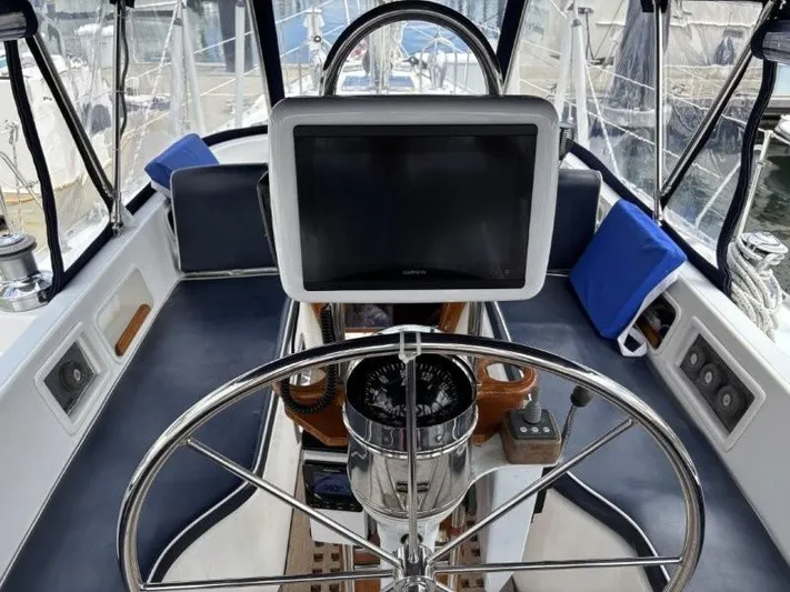 Seacape Yacht Photos Pics Cockpit of a 1996 Hylas 46 sailboat with steering wheel and navigation equipment.