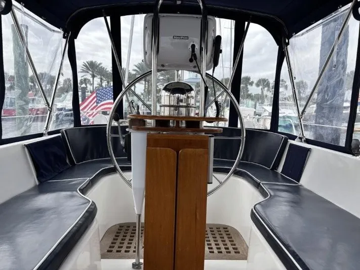 Seacape Yacht Photos Pics Cockpit of a 1996 Hylas 46 sailboat with steering wheel and American flag.