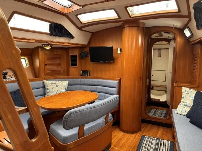 Seacape Yacht Photos Pics Interior of 1996 Hylas 46 yacht with wood finish and cozy seating area.