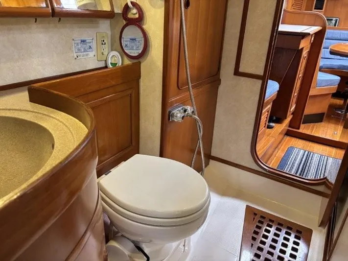 Seacape Yacht Photos Pics 1996 Hylas 46 yacht bathroom with wooden cabinetry and modern fixtures.