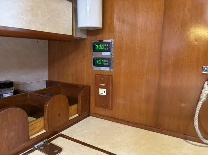 Seacape Yacht Photos Pics Interior of a 1996 Hylas 46 yacht with wooden cabinetry and digital displays.