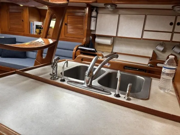 Seacape Yacht Photos Pics Interior of 1996 Hylas 46 yacht featuring a dual sink and wooden cabinetry.