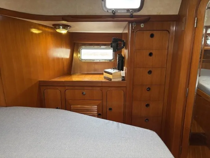 Seacape Yacht Photos Pics Interior of a 1996 Hylas 46 yacht cabin with wooden cabinetry and a small window.