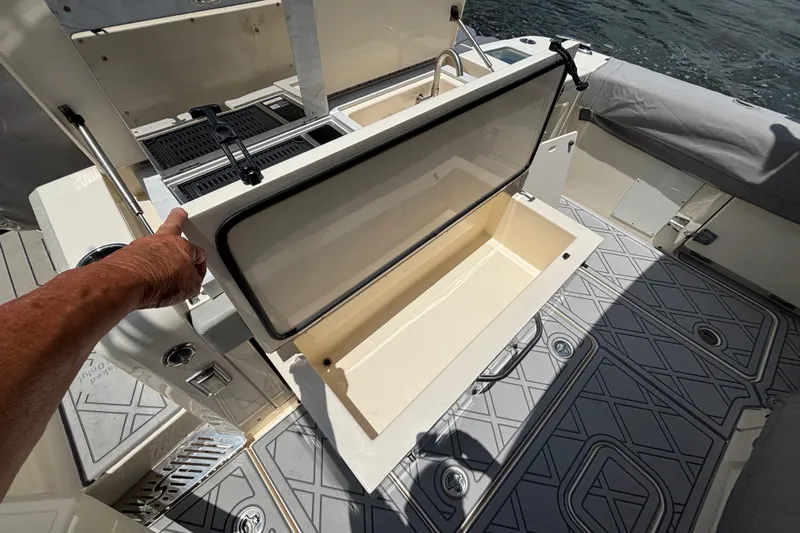 Maryanray Yacht Photos Pics 2024 Scout 377 LXF boat interior with open storage compartment and deck view.