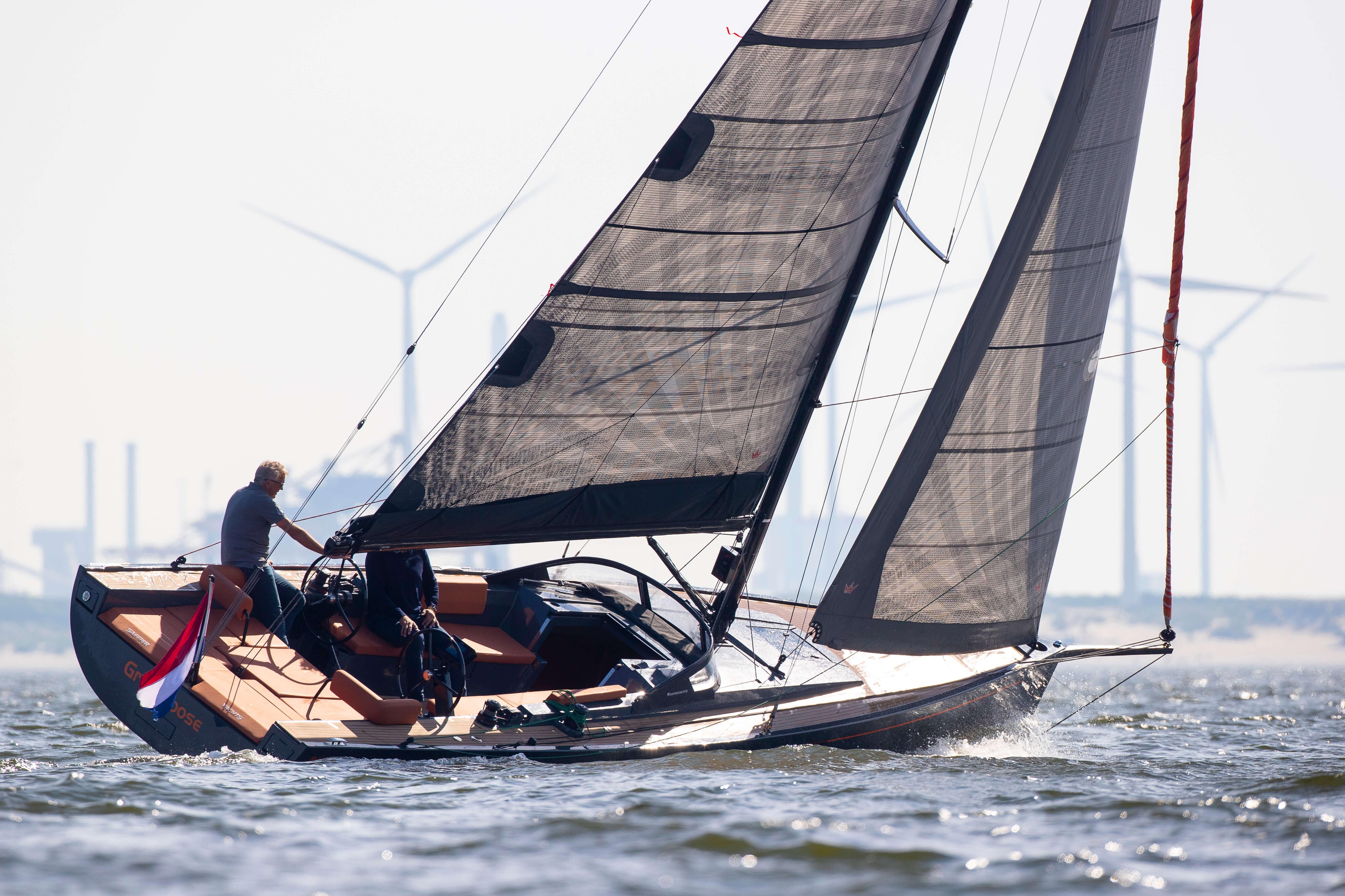 Saffier SE 33 Life 2026 sailing yacht on water with wind turbines in background.