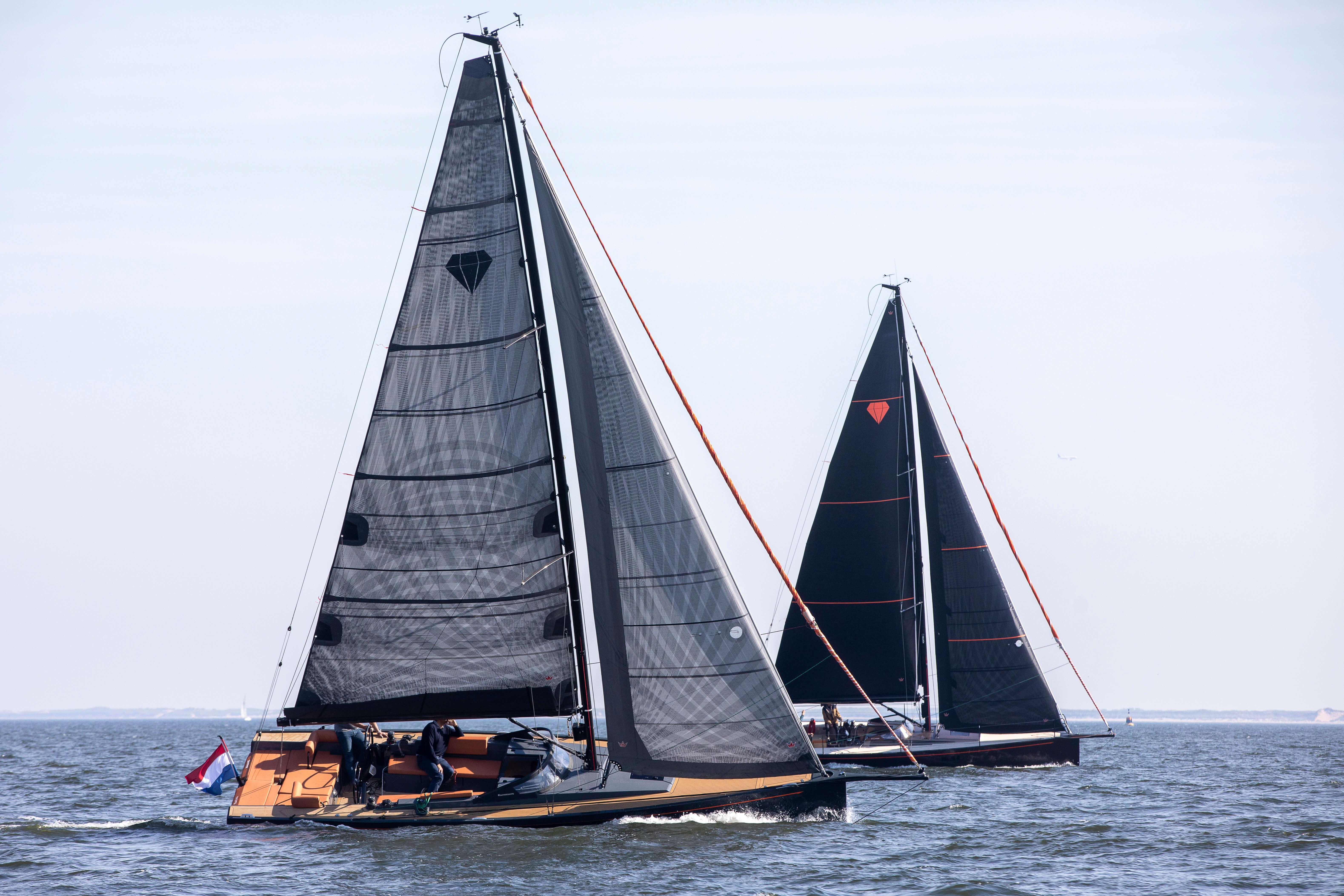 Saffier SE 33 Life sailboats racing on open water, 2026 model, with sleek black sails.
