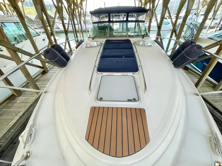 Hailey Brae Yacht Photos Pics 2021 Custom Express Cruiser docked, featuring sleek design and spacious deck with wood accents.