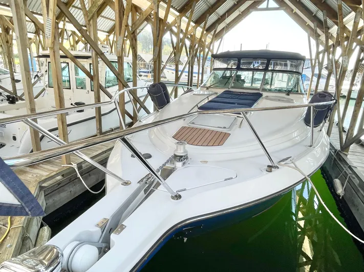 Hailey Brae Yacht Photos Pics 2021 Custom Express Cruiser docked in a covered marina, showcasing sleek design and modern features.