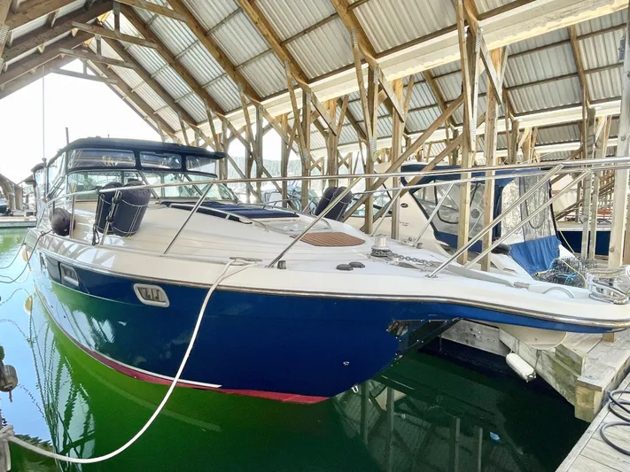 Hailey Brae Yacht Photos Pics 2021 Custom Express Cruiser docked in a covered marina.