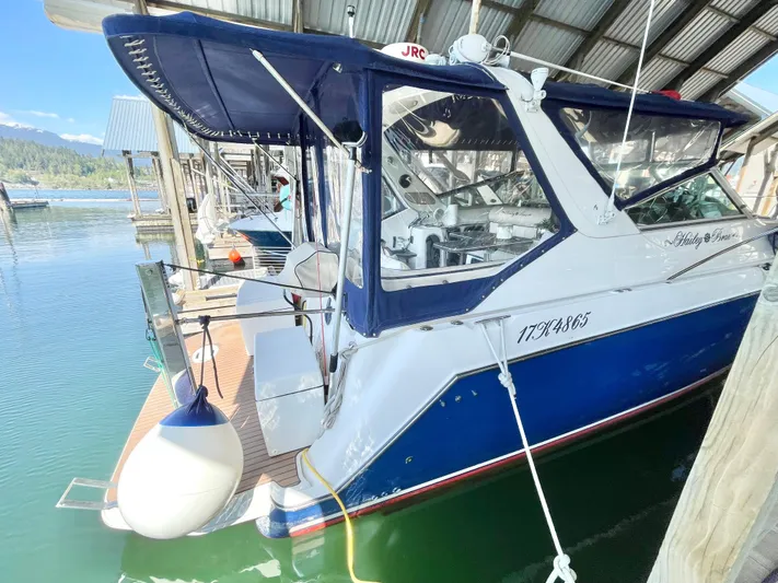 Hailey Brae Yacht Photos Pics 2021 Custom Express Cruiser docked under a covered marina.