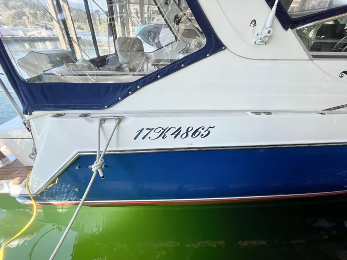 Hailey Brae Yacht Photos Pics 2021 Custom Express Cruiser docked, showing registration number 17K4865 on the hull.