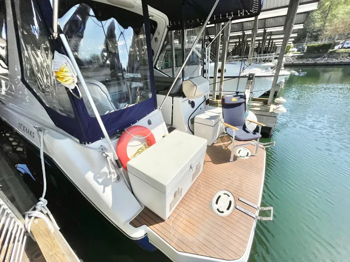 Hailey Brae Yacht Photos Pics 2021 Custom Express Cruiser docked, featuring a spacious deck and modern design.