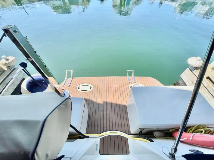 Hailey Brae Yacht Photos Pics 2021 Custom Express Cruiser's rear deck with water view and seating area.