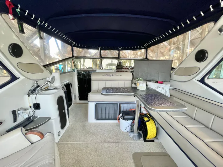 Hailey Brae Yacht Photos Pics Interior of a 2021 Custom Express Cruiser with seating and table setup.