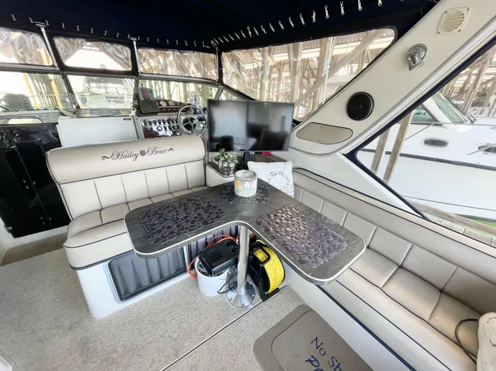 Hailey Brae Yacht Photos Pics Luxurious 2021 Custom Express Cruiser interior with seating, table, and navigation equipment.