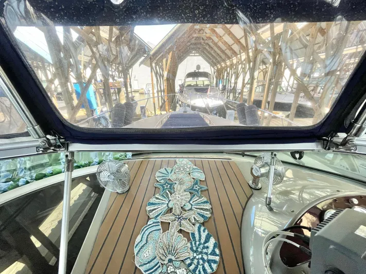Hailey Brae Yacht Photos Pics 2021 Custom Express Cruiser interior with decorative table and marina view.