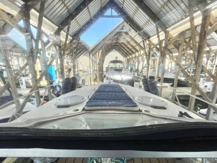 Hailey Brae Yacht Photos Pics 2021 Custom Express Cruiser docked in a covered marina, showcasing sleek design and modern features.