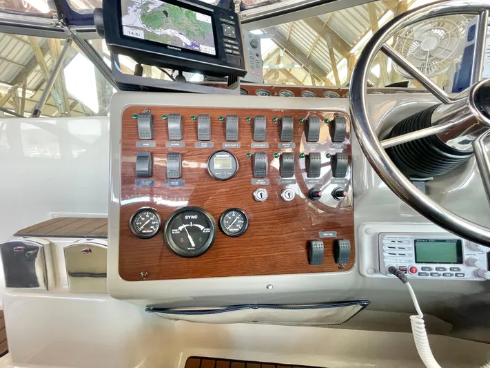 Hailey Brae Yacht Photos Pics 2021 Custom Express Cruiser dashboard with controls, gauges, and navigation system.