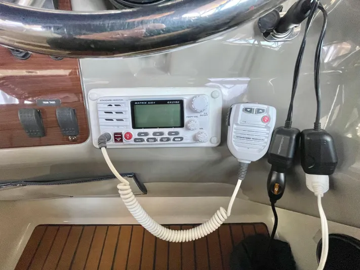 Hailey Brae Yacht Photos Pics 2021 Custom Express Cruiser dashboard with marine radio and controls.