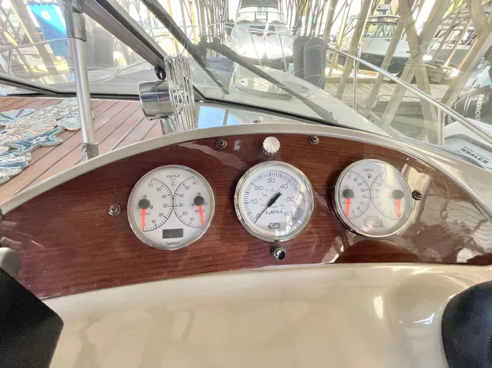 Hailey Brae Yacht Photos Pics Dashboard of a 2021 Custom Express Cruiser with gauges and wooden paneling.