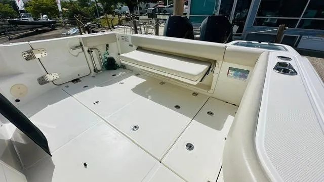  Yacht Photos Pics 2023 Boston Whaler 325 boat deck with seating and storage compartments.