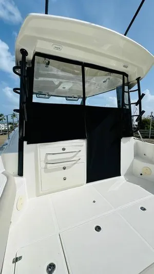  Yacht Photos Pics 2023 Boston Whaler 325 boat interior with storage drawers and black cover.