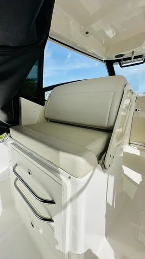  Yacht Photos Pics 2023 Boston Whaler 325 boat interior with cushioned seating and storage.