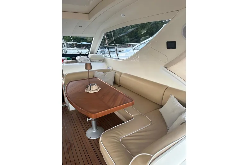  Yacht Photos Pics Luxurious interior of 2005 Uniesse 48 Open yacht with elegant seating and wooden table.