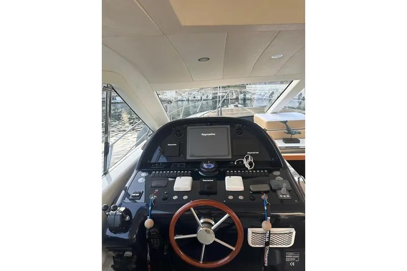  Yacht Photos Pics Helm of 2005 Uniesse 48 Open yacht with navigation equipment and steering wheel.