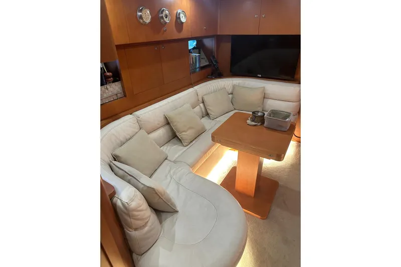  Yacht Photos Pics Luxurious interior of 2005 Uniesse 48 Open yacht with plush seating and wooden table.