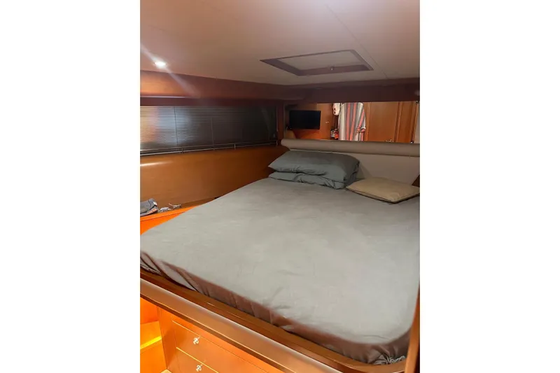  Yacht Photos Pics Interior cabin of 2005 Uniesse 48 Open yacht with bed and wooden furnishings.