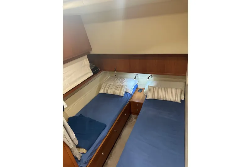  Yacht Photos Pics 2005 Uniesse 48 Open yacht cabin with twin beds and wooden cabinetry.
