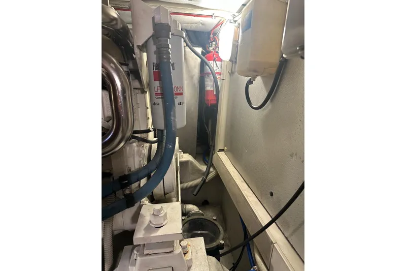  Yacht Photos Pics Engine room of 2005 Uniesse 48 Open yacht, showing mechanical components and hoses.