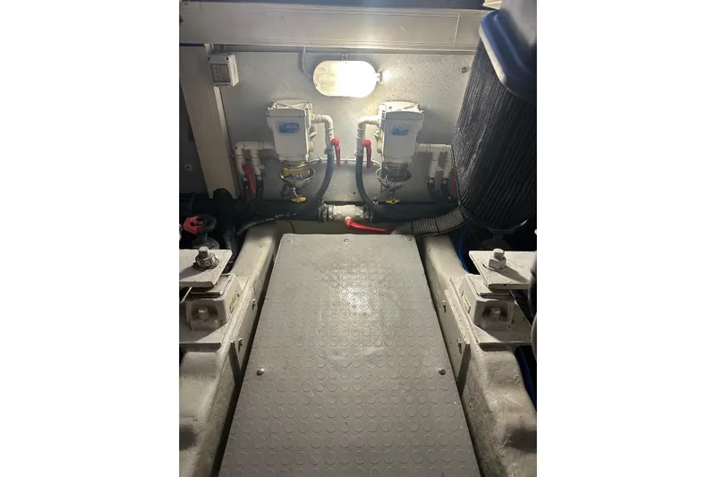  Yacht Photos Pics Engine room of 2005 Uniesse 48 Open yacht, featuring mechanical components and lighting.