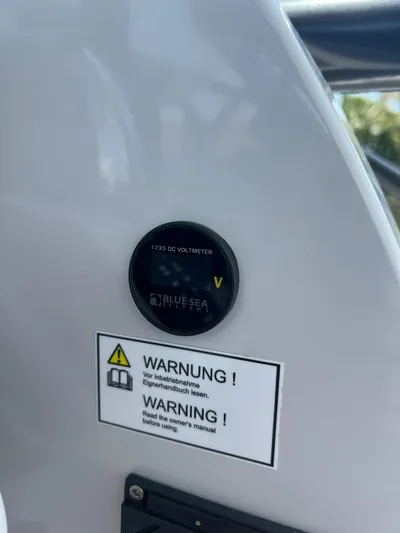  Yacht Photos Pics RYCK 28 boat dashboard with voltmeter and warning labels, 2023 model.