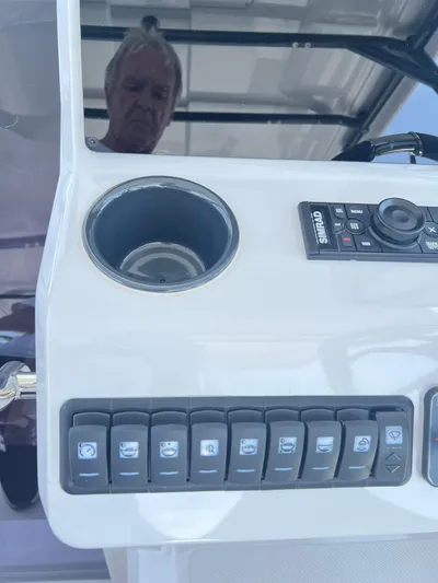  Yacht Photos Pics Control panel of 2023 RYCK 28 boat with switches and cup holder.
