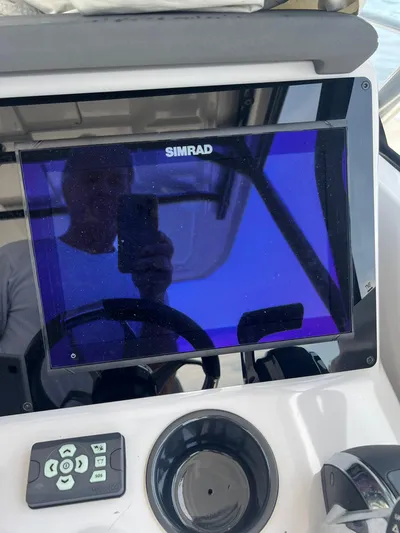  Yacht Photos Pics Simrad display on 2023 RYCK 28 boat dashboard with control panel.