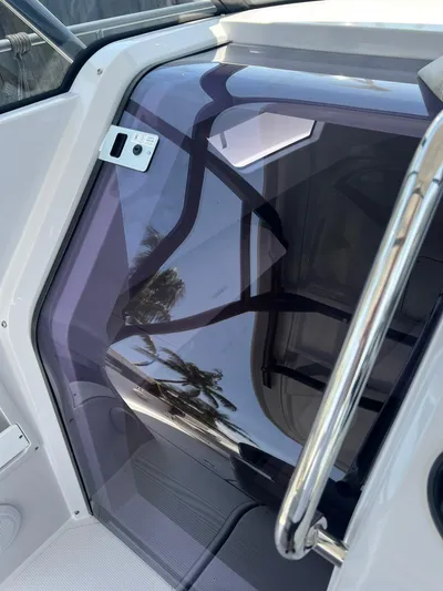  Yacht Photos Pics 2023 RYCK 28 boat cabin entrance with sleek design and tinted glass door.