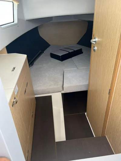  Yacht Photos Pics 2023 RYCK 28 boat interior with cozy cabin and modern wood finish.