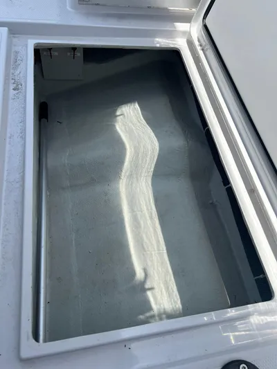  Yacht Photos Pics Open storage compartment on a 2023 RYCK 28 boat, showing interior details.