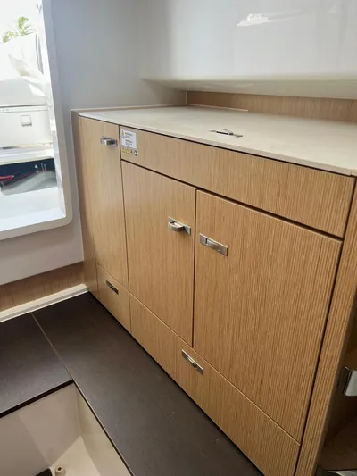  Yacht Photos Pics 2023 RYCK 28 boat interior with sleek wooden cabinetry and modern design.