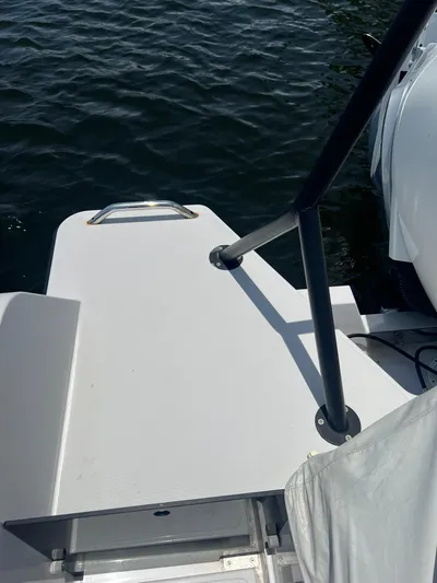  Yacht Photos Pics 2023 RYCK 28 boat platform with railing on calm water.