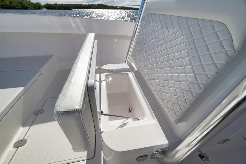 Bahama 41 Yacht Photos Pics 2024 Bahama 41 RD boat with luxurious seating and storage, overlooking serene water.