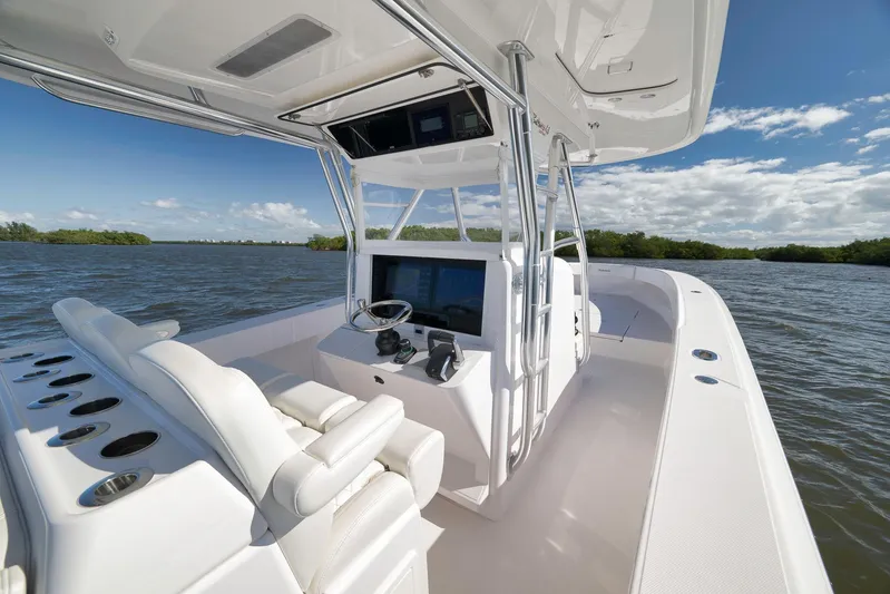 Bahama 41 Yacht Photos Pics 2024 Bahama 41 RD boat interior with helm, white seating, and scenic water view.