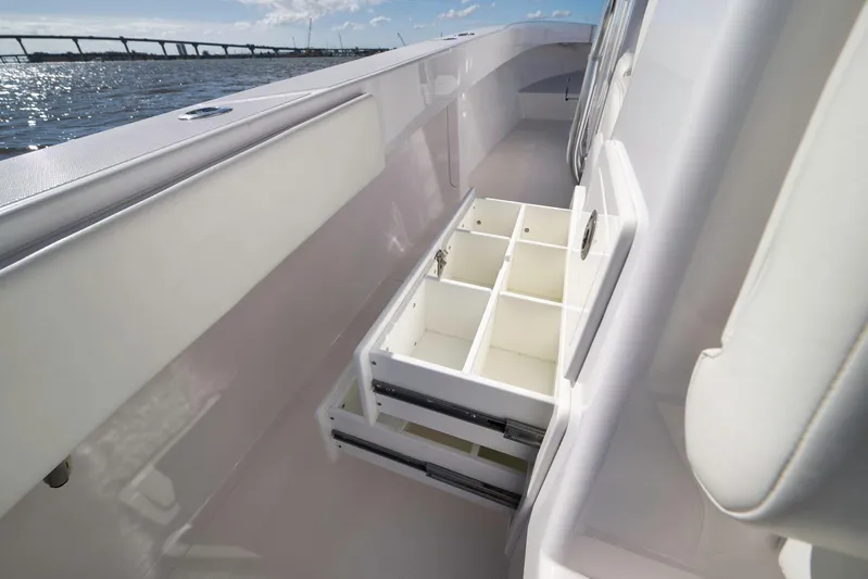 Bahama 41 Yacht Photos Pics 2024 Bahama 41 RD boat with open storage compartments, ocean view in background.