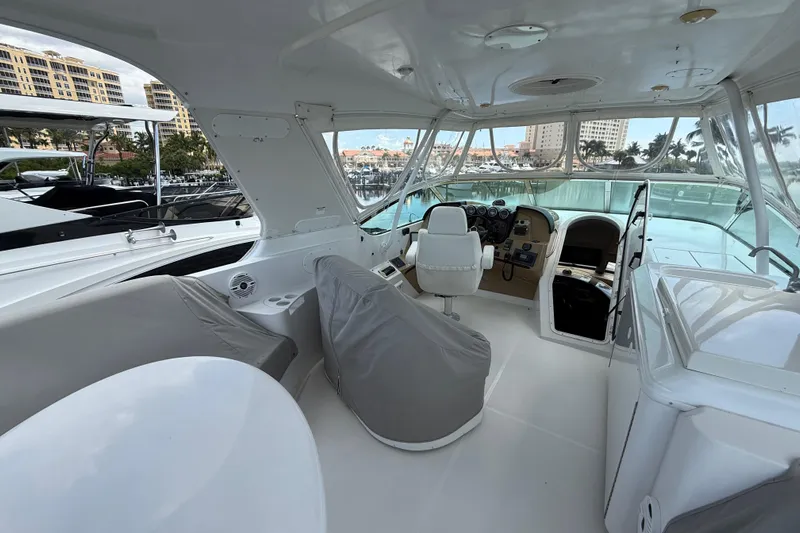  Yacht Photos Pics 2002 Carver 570 Voyager Pilothouse interior with helm, seating, and marina view.